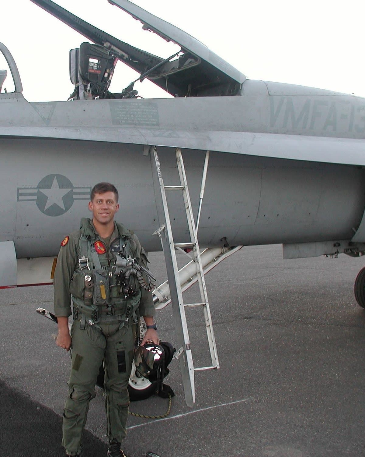Mike Kloch in flight gear beside a VMFA-134 F/A-18 Hornet.